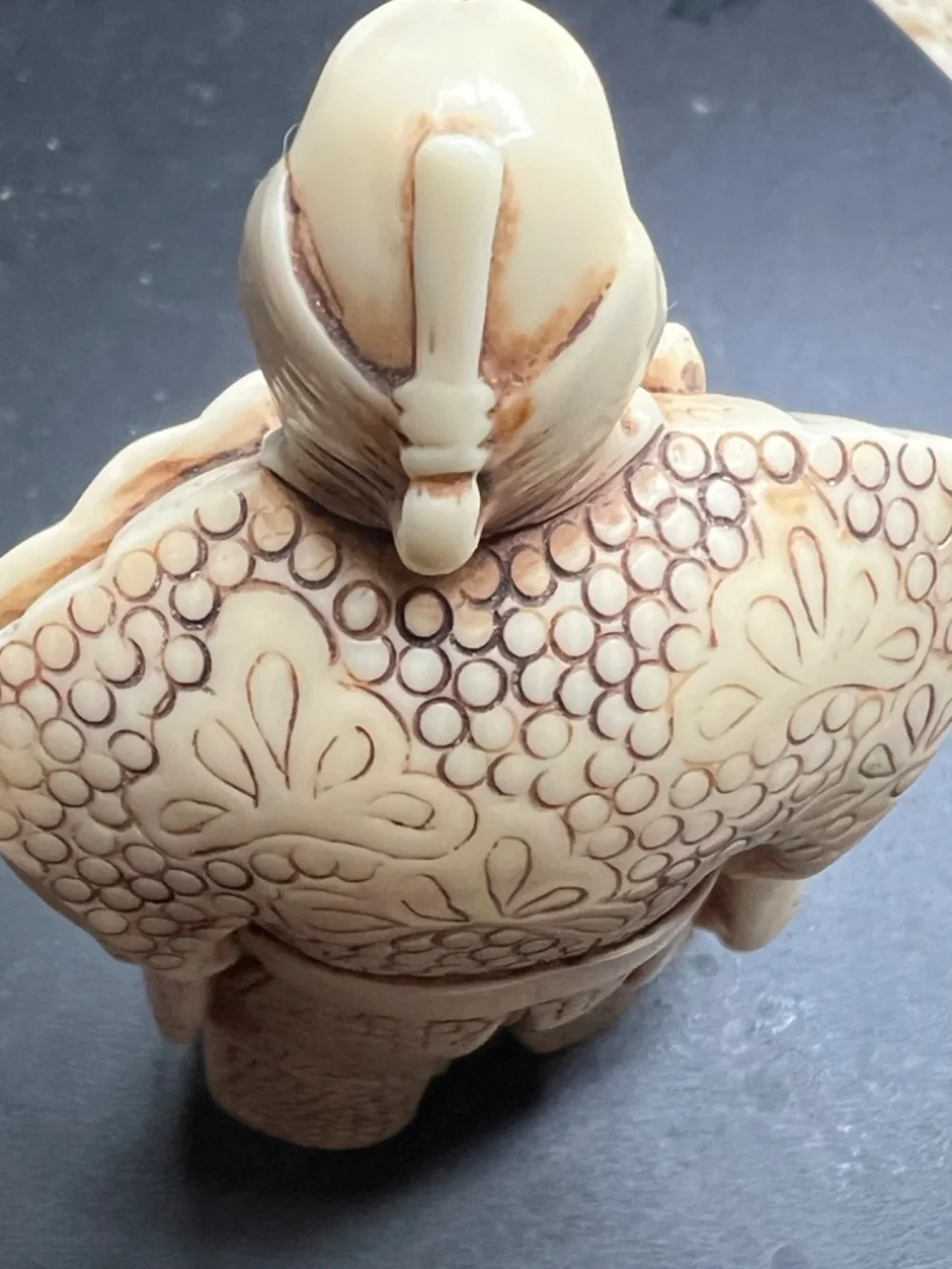Hand-carved Japanese figurine likely a samurai or similar figure